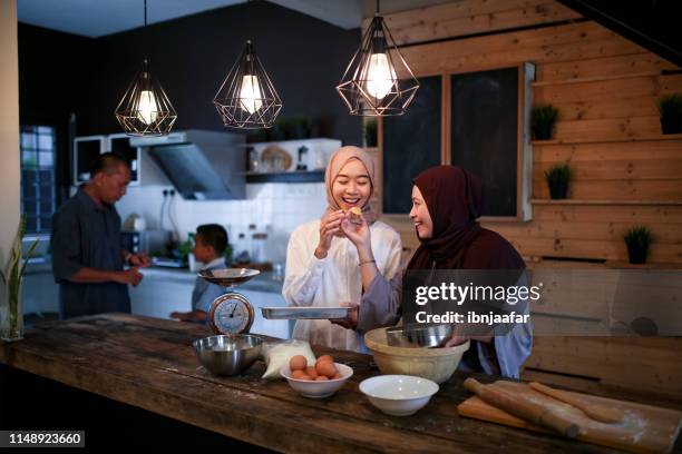 mother and daughter baking in kitchen - ramadan family stock pictures, royalty-free photos & images