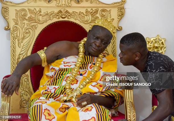 Man talks with King Amon N'Douffou V , King of Krindjabo, capital of the Sanwi Kingdom, in the southeast of the Ivory Coast, during an event with...