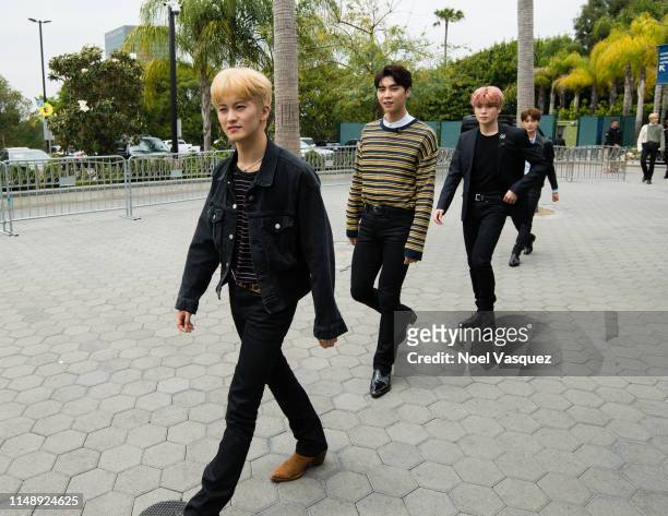Mark Lee, Johnny and Jaehyun of NCT 127 visit "Extra"at Universal Studios Hollywood on May 13, 2019 in Universal City, California.