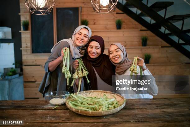 moeder met twee dochter bereiden van voedsel in de keuken - eid al fitr celebration to mark the end of ramadan stockfoto's en -beelden