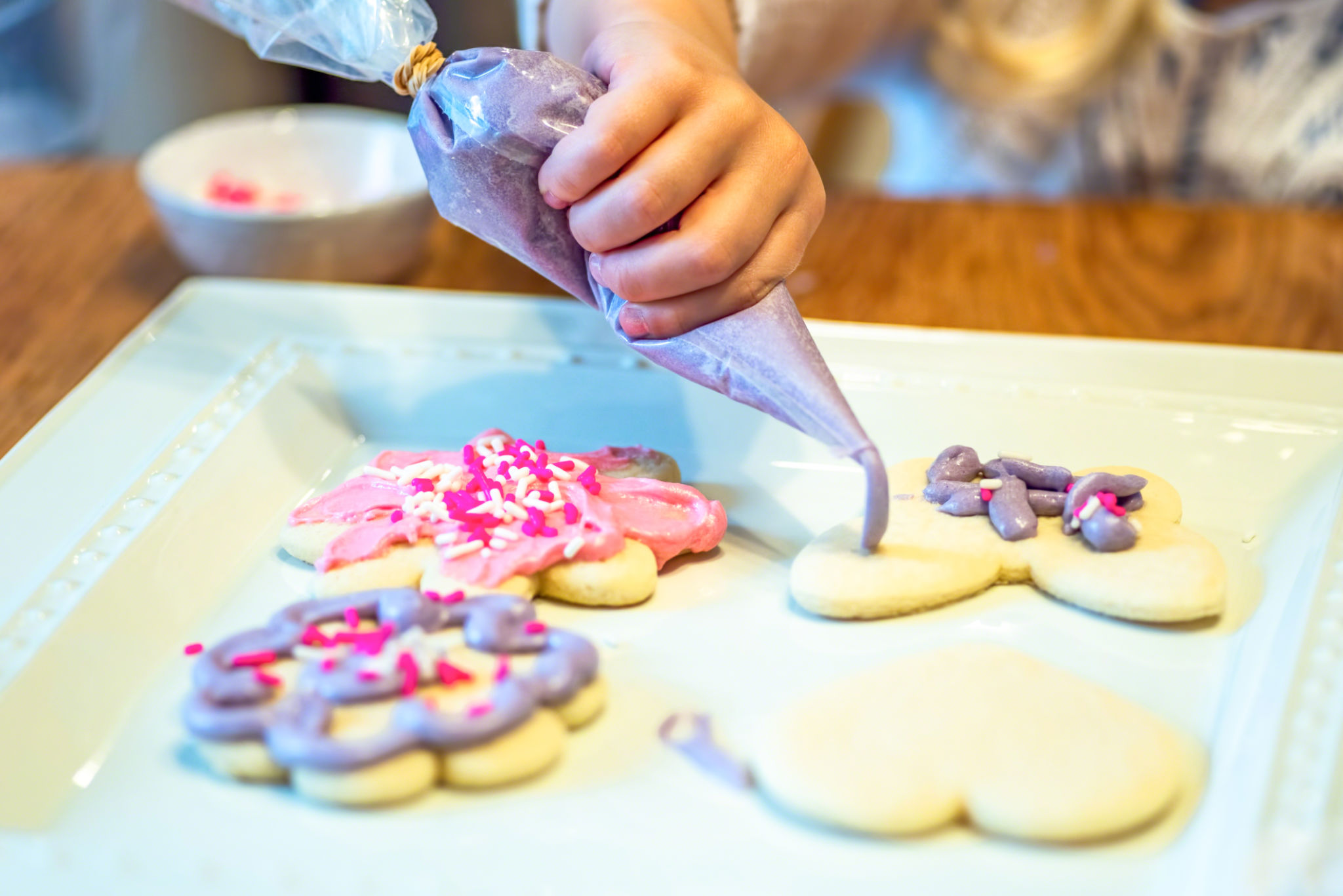 hands decorating cookies