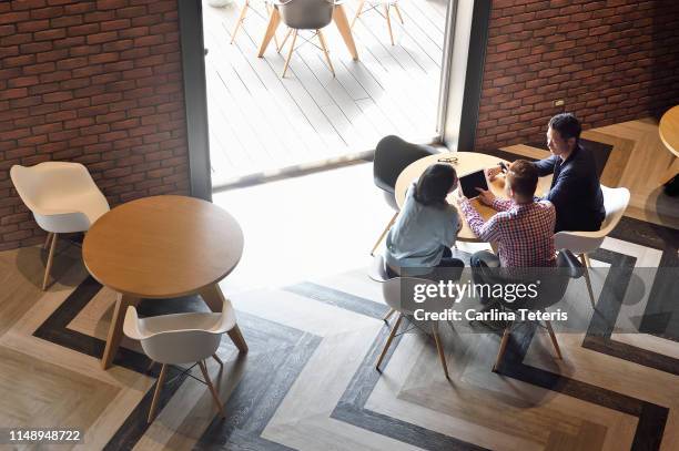 overhead view of creatives working together in a co-working space - taiwanese culture stockfoto's en -beelden