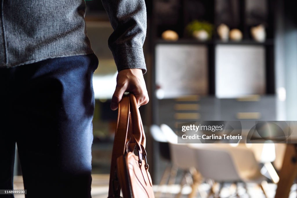 Man's body walking through an office