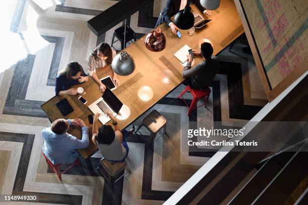 high angle view of young business executives working together - nuova impresa foto e immagini stock