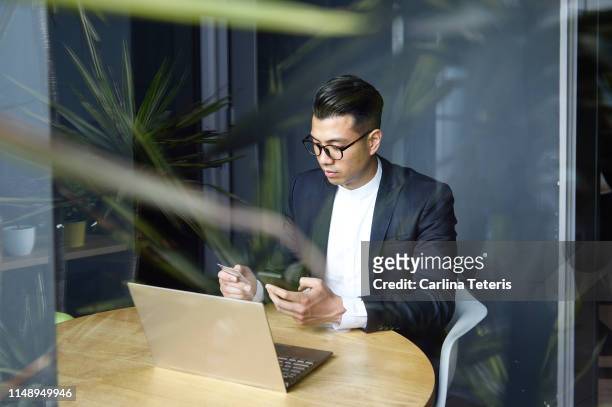 Handsome Asian man making online purchases with a credit card