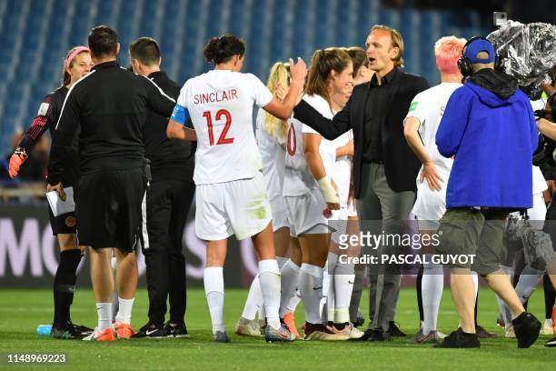 Canada's coach Kenneth Heiner-Moller celebrate with his players at the end of the France 2019 Women's World Cup Group E football match between Canada...