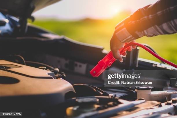 jumping battery car. - car battery stock pictures, royalty-free photos & images