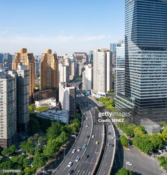 aerial view of traffic on road junction in modern city - shanghai aerial view motorway skyline stock-fotos und bilder