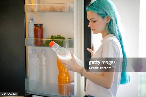 anime like young woman with turquoise hair holding milk bottle - half open stock pictures, royalty-free photos & images