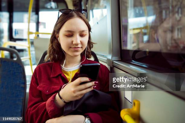 teenage girl listening to music in bus - girl with earphones stock pictures, royalty-free photos & images