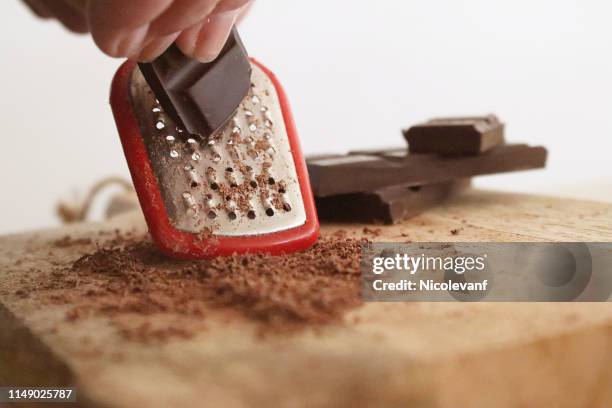 woman grating a bar of chocolate - grated stock pictures, royalty-free photos & images