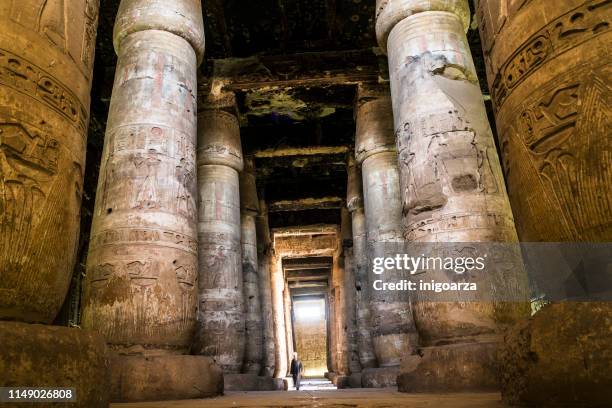 man walking through temple of seti i, abydos, egypt - abydos imagens e fotografias de stock