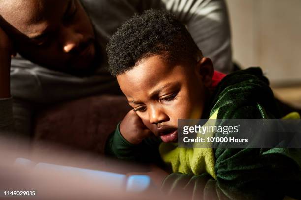 Toddler watching tablet with open mouth