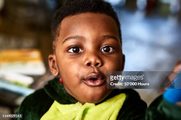 close up portrait of toddler with open mouth looking at camera - surprise portrait photos et images de collection