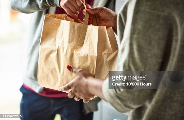 close up of woman receiving take away food delivery - livre photos et images de collection
