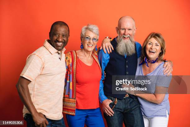 group studio portrait - portrait orange background stock pictures, royalty-free photos & images