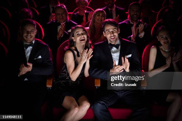 couple applauding while watching opera - opera audience stock pictures, royalty-free photos & images