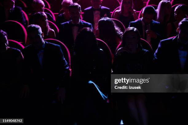 crowd in dark watching opera in theater - movie theater crowd silhouette stock pictures, royalty-free photos & images