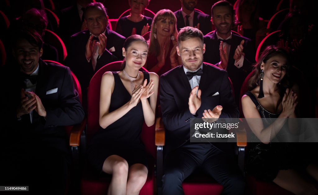 Mature couple clapping while watching opera