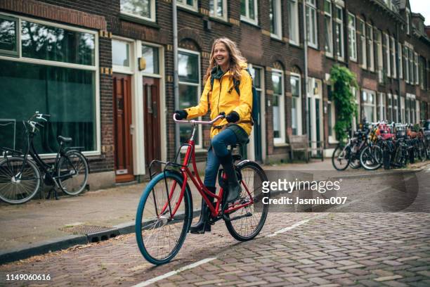 dutch woman with bicycle in utrecht - utrecht stock pictures, royalty-free photos & images