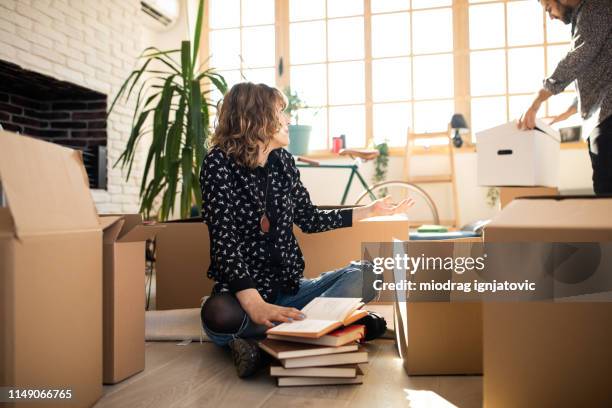 hipster couple at new house - couple seated apartment hipster imagens e fotografias de stock