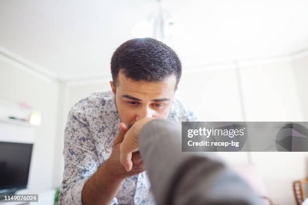 son kissing his father’s hand for celebrating eid al-fitr (end of ramadan) - kissing hand stock pictures, royalty-free photos & images