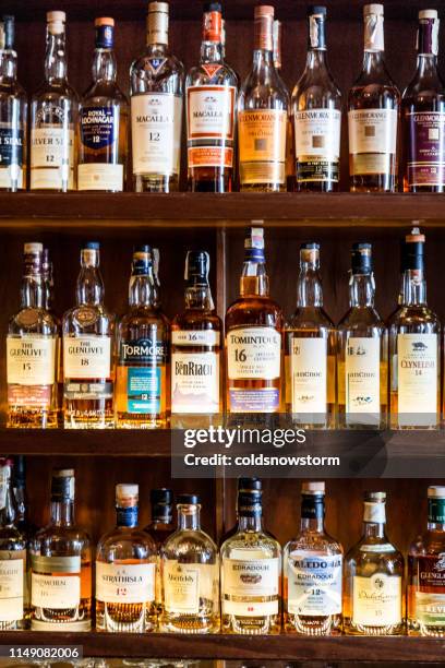 large selection of scottish malt whisky at the bar - continental_shelf stock pictures, royalty-free photos & images