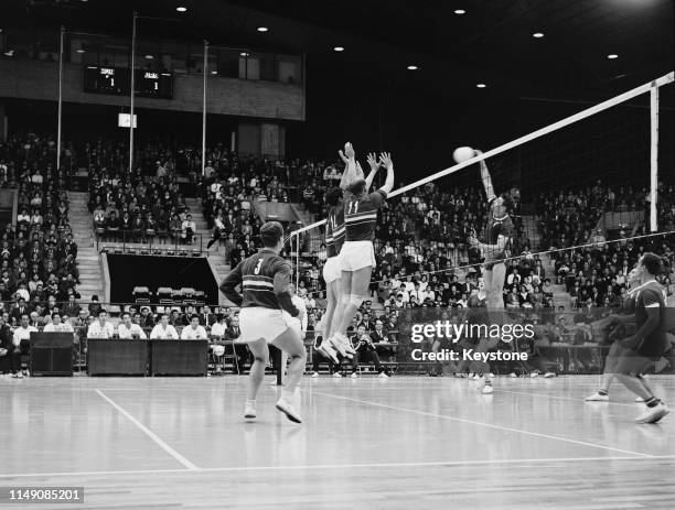 Yury Chesnokov of the Soviet Union attempts a kill ball against Tibor Florian, Ferenc Janosi and Mihaly Tatar of Hungary during their Men's Olympic...