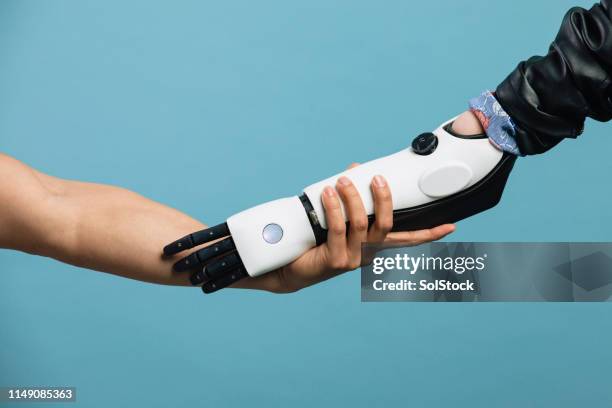 holding hands - robot hand human hand stock pictures, royalty-free photos & images