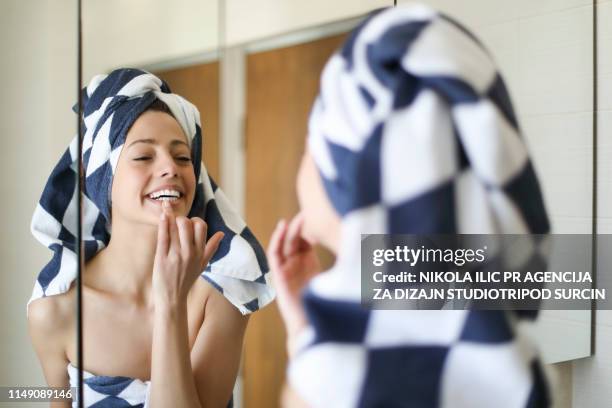 young woman puting make up on - charming stock pictures, royalty-free photos & images
