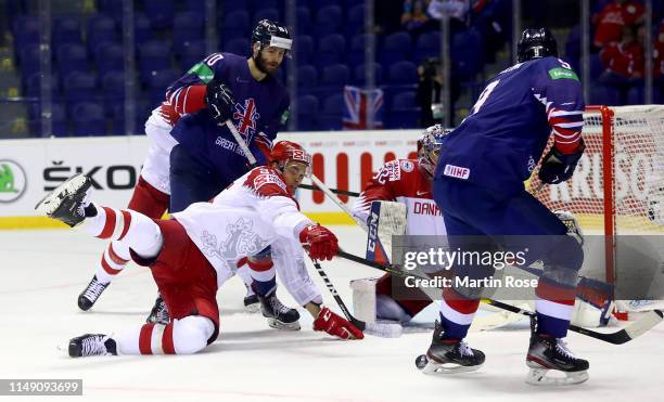 Robert Farmer of Great Britain challenges Oliver Lauridsen of Denmark during the 2019 IIHF Ice Hockey World Championship Slovakia group A game...