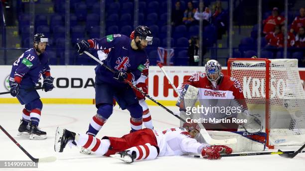 Robert Farmer of Great Britain challenges Oliver Lauridsen of Denmark during the 2019 IIHF Ice Hockey World Championship Slovakia group A game...