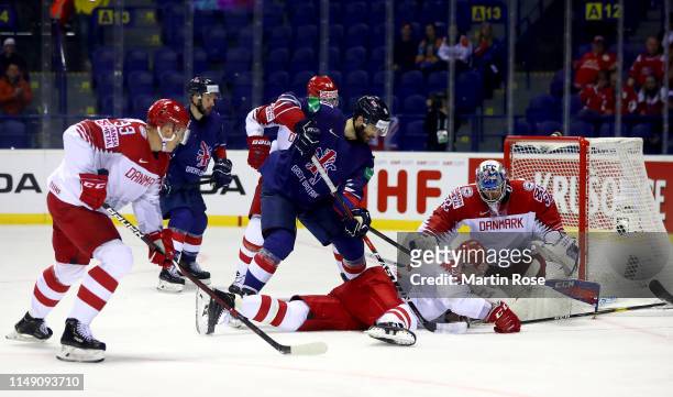 Robert Farmer of Great Britain challenges Oliver Lauridsen of Denmark during the 2019 IIHF Ice Hockey World Championship Slovakia group A game...
