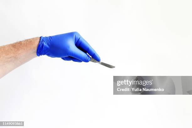 doctor's hand holding a scalpel with clipping path - skalpell stock-fotos und bilder