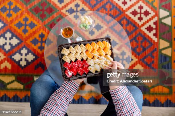 eating sushi at home, directly above personal perspective view - eating sushi stock-fotos und bilder