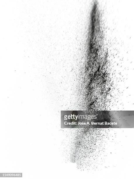 explosion by an impact of a cloud of particles of powder of color black on a white background. - smoke white background stockfoto's en -beelden