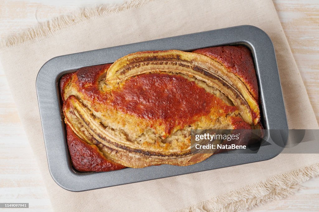Banana bread in a pan. Cake with banana, chocolate, walnut. Traditional american cuisine