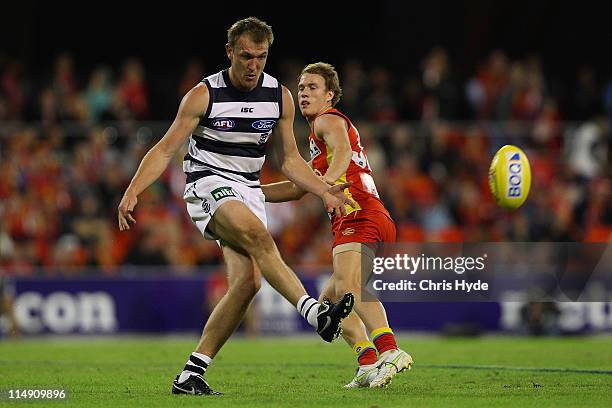 Darren Milburn of the Cats kicks during the round 10 AFL match between the Gold Coast Suns and Geelong Cats at Metricon Stadium on May 28, 2011 in...