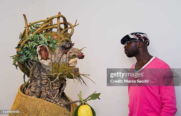 Man looks at a sculpture interpretation of Arcimboldo's "Winter" portrait by Philip Haas at the press preview of Ileana Sonnabend "Un Ritratto...