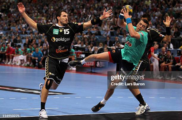 Siarhei Rutenka of Barcelona is challenged by Michael Mueller and Zarko Sesum of Rhein Neckar during the EHF Final Four semi final match between...