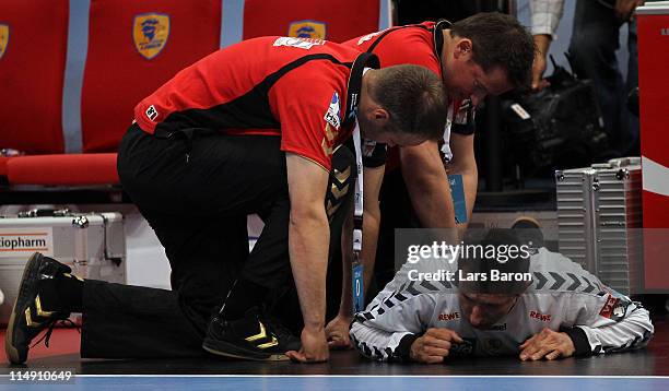 Goalkeeper Slawomir Szmal of Rhein Neckar lies injured on the pitch during the EHF Final Four semi final match between Rhein-Neckar Loewen and FC...