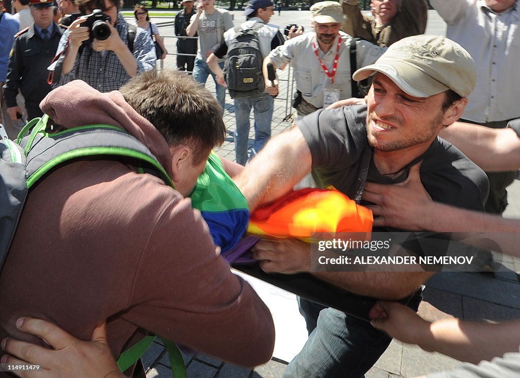 Gay Rights Men A man hits a gay rights activists during their attempt to hold an ...