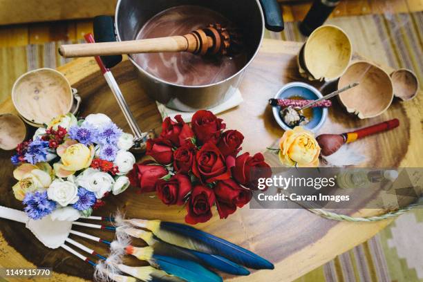 table filled with an assortment of tools for cacao ceremony - burning rose bildbanksfoton och bilder