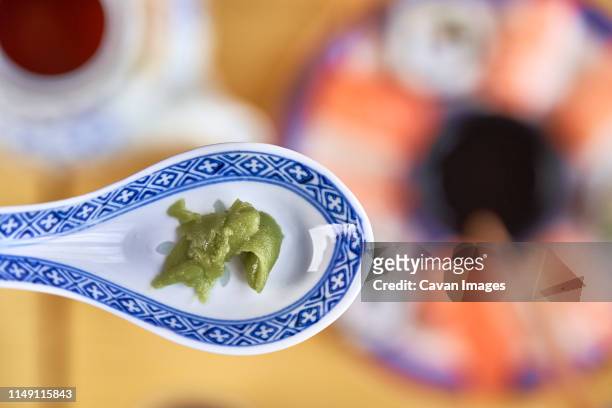 wasabi sauce in ceramic spoon. - wasabi stock pictures, royalty-free photos & images