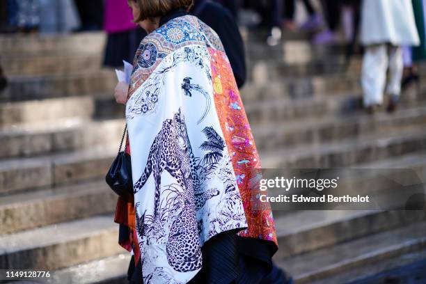 Guest wears a large stole made from different silk scarves and especially the "Jungle Love" one from Hermes, outside the Opera Garnier 350th...