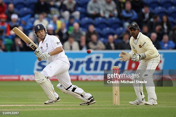 Jonathan Trott of England plays to the offside as wicketkeeper Prasanna Jayawardene looks on during day three of the 1st npower test match between...
