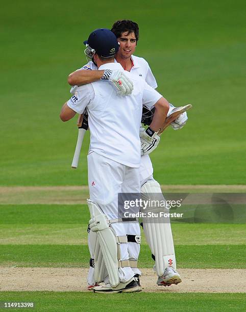 England batsman Alastair Cook celebrates his century with partner Jonathan Trott during day three of the 1st npower test match between England and...