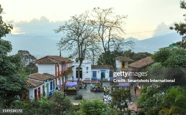 pueblito paisa main square at early dusk on cerro nutibara of medellin, antioquia, colombia - camponês imagens e fotografias de stock