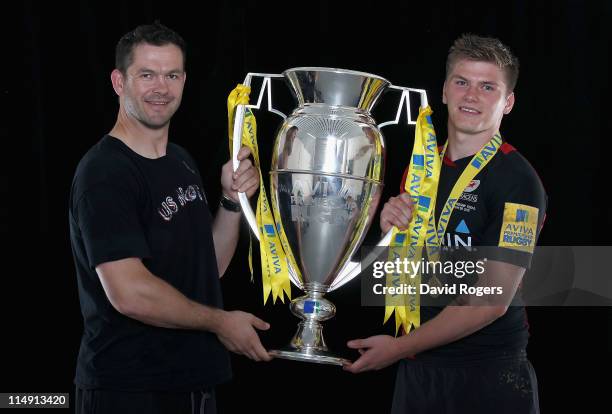 Saracens fly half Owen Farrell and his father Andy Farrell pose with the Aviva Premiership trophy in the changing room after the AVIVA Premiership...