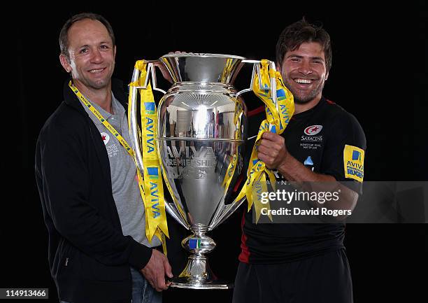 Technical Director of Saracens, Brendan Ventor, and 'Man of the Match' Schalk Brits of Saracens pose with the trophy following victory in the AVIVA...